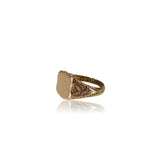 Gold ring with rose design on a white background