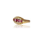 Gold ring with red gemstones on a white background