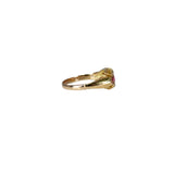 Gold ring with a red gemstone on a white background