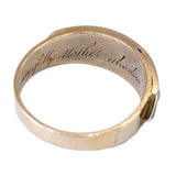 Gold ring with engraved text on a white background