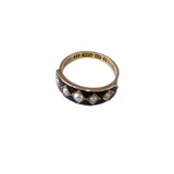 Gold and black ring with pearl accents on a white background