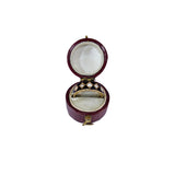 Open jewelry box with a ring inside on a white background