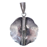 silver pendant on white background
