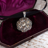 Decorative pendant with crystals on a purple velvet surface