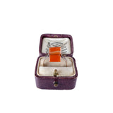 Ring in a purple jewelry box on a white background