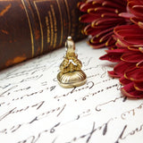 Gold stamp on an old document with a red flower