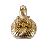 Gold-colored metal fob on a white background