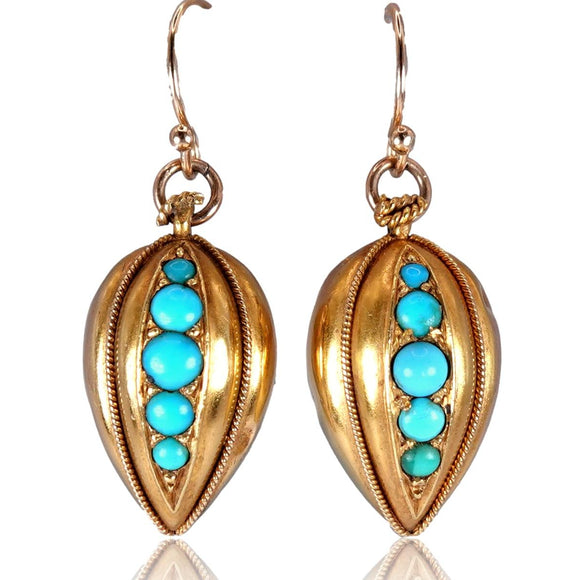 Gold earrings with turquoise stones on a white background