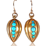 Gold earrings with turquoise stones on a white background