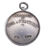 Silver pendant with engraved text on a white background