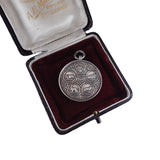 Silver medallion with engravings in a velvet-lined box