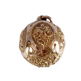 Gold pendant with intricate design on a white background