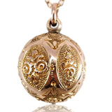Gold necklace with an ornate pendant on a white background