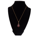 Gold necklace with a red pendant on a black mannequin bust against a white background