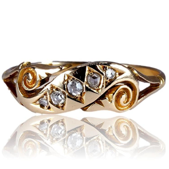 Gold ring with diamond accents on a white background