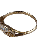 Gold ring with intricate design on a white background