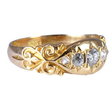 Gold ring with diamond accents on a white background