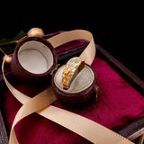 Gold ring with diamond in a jewelry box on a dark background