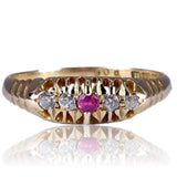 Gold ring with a pink gemstone on a white background