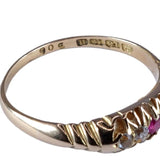 Gold ring with embedded gemstones on a white background