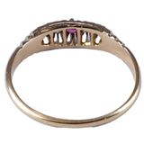 Gold ring with a central gemstone on a white background