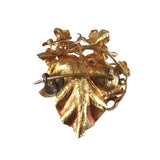 Gold leaf brooch on a white background