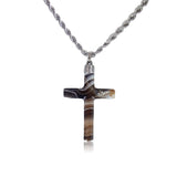 Cross-shaped pendant on a chain against a white background