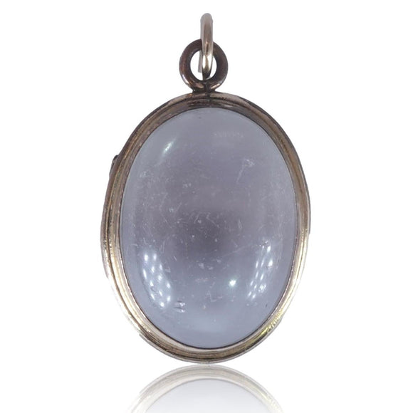 Silver pendant with a blue-green stone on a white background