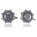 Pair of silver cufflinks with intricate design on a white background
