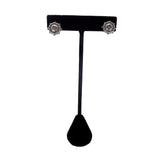 Black T-shaped earring stand with silver earrings on a white background