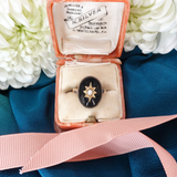 Ring in a jewelry box with floral background