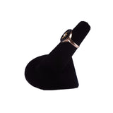 Black ring holder with a ring on a white background