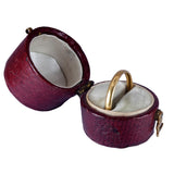 Open purple jewelry box with a gold ring inside on a white background