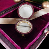 Gold ring in a jewelry box with a pink interior