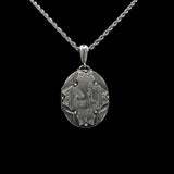 Silver pendant necklace on a black background