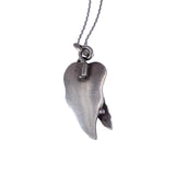 Silver wing-shaped pendant on a chain against a white background