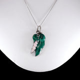 Green leaf-shaped pendant on a silver chain against a white background
