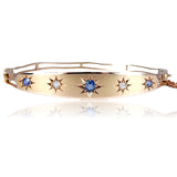 Gold bracelet with star-shaped gemstones on a white background