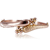 Gold ring with decorative elements on a white background