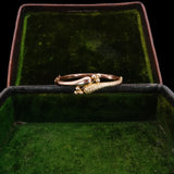 Gold ring with green gemstone in a green velvet box