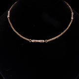 Gold chain bracelet on a black background