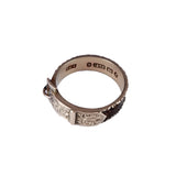 Silver ring with intricate design on a white background