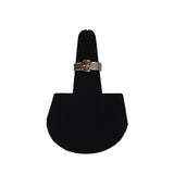Silver ring on a black stand against a white background