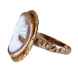 Gold ring with a white stone on a white background
