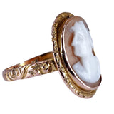 Gold ring with a cameo design on a white background