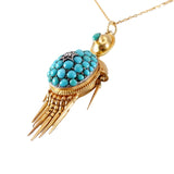 Gold and turquoise pendant necklace on a white background