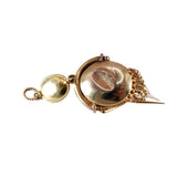 Gold brooch with circular design on a white background