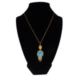 Necklace with a blue pendant on a black mannequin bust