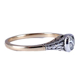 Gold ring with a diamond on a white background