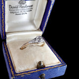 Diamond ring in a David Henderson jewelry box on a black background